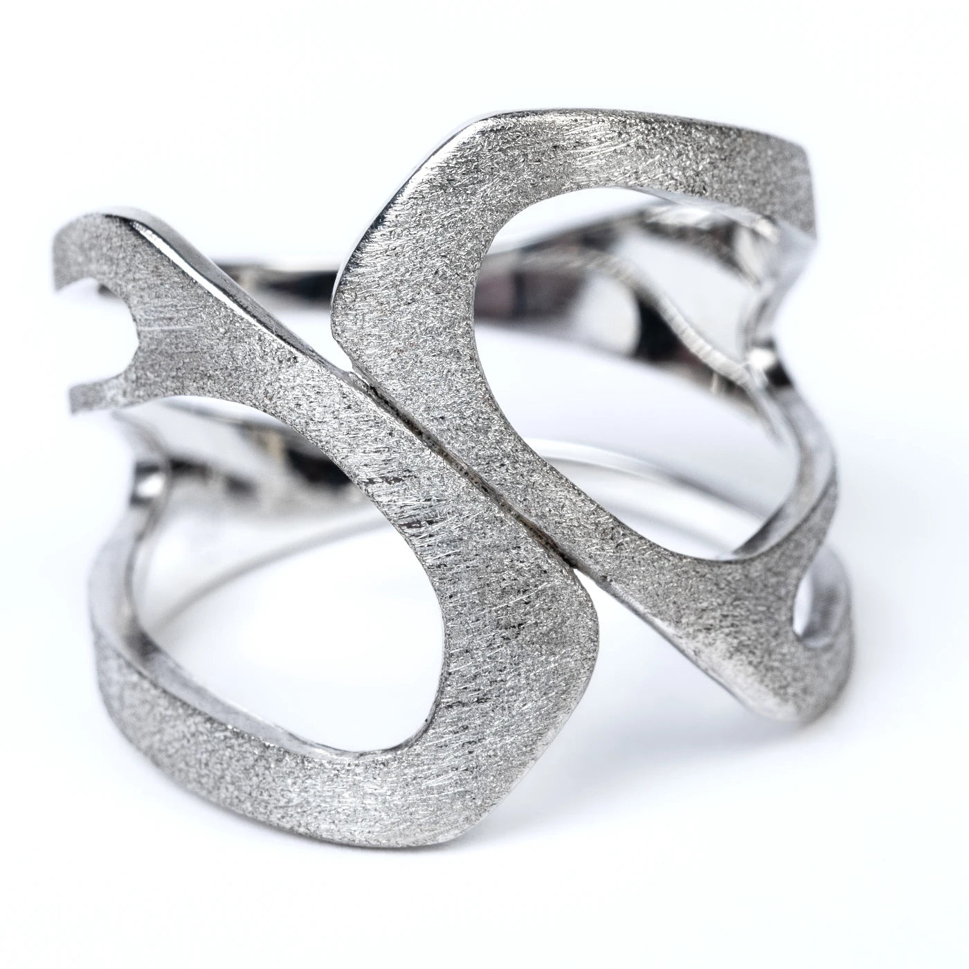 Silver ring with textured design on a white background