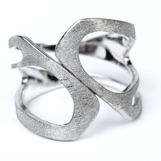 Silver ring with textured design on a white background